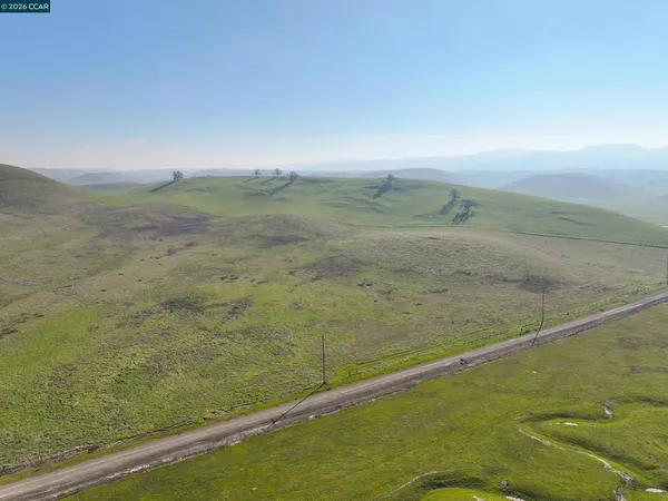 an aerial view of a house with a mountain