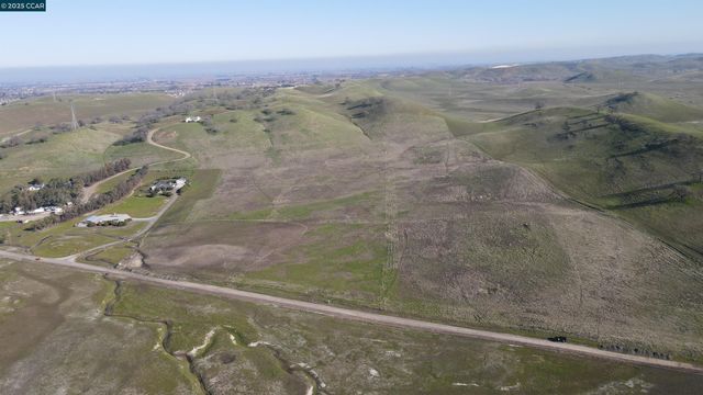 a view of a dry yard with mountain