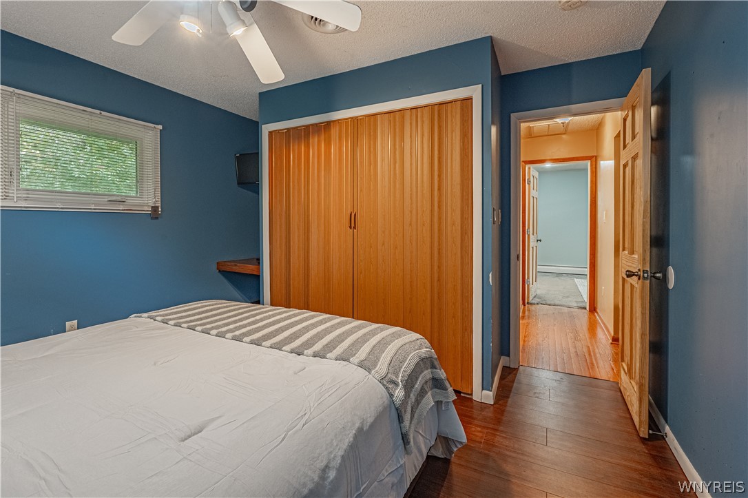 6775 Bear Ridge Road Pendleton, NY 14094 - Photo 23 of 48 Gleaming hardwood floors and a spacious closet define this inviting bedroom space.