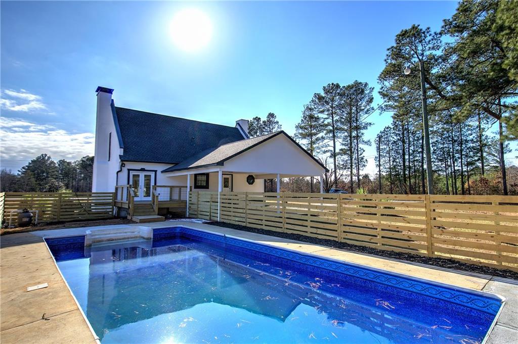 2193 West Ellis Road Griffin, GA 30223 - Photo 22 of 26 a view of a house with pool and chairs