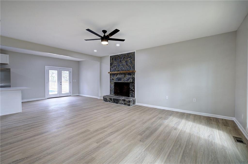 2193 West Ellis Road Griffin, GA 30223 - Photo 3 of 26 a view of an empty room with wooden floor and a window