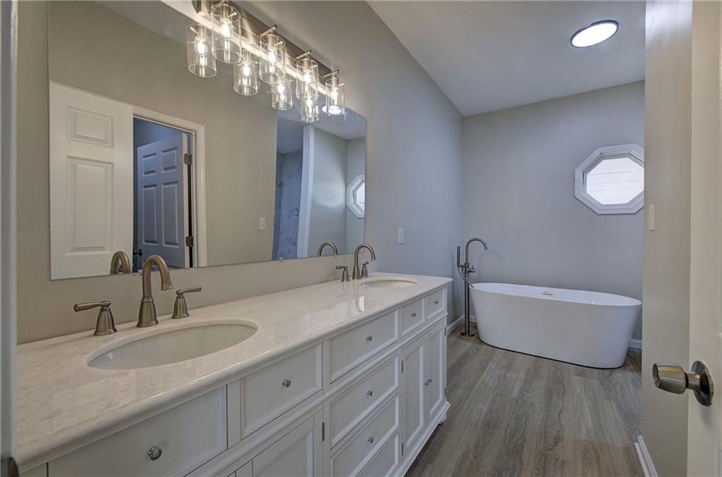 2193 West Ellis Road Griffin, GA 30223 - Photo 10 of 26 a bathroom with a double vanity sink and a mirror