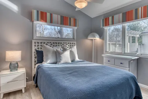 a large bed sitting in a bedroom next to a window