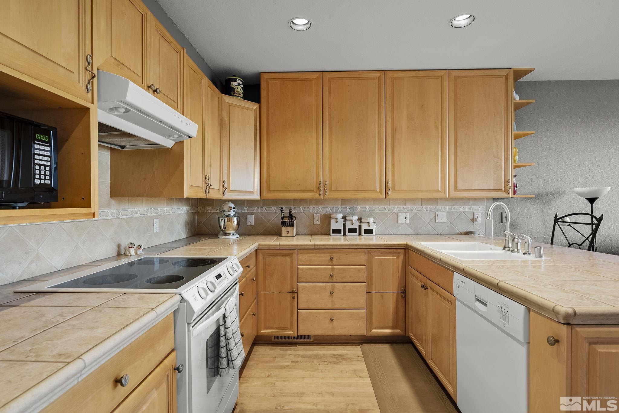 2390 High Terrace Drive Reno, NV 89509 - Photo 12 of 36 a kitchen with a sink stove and cabinets