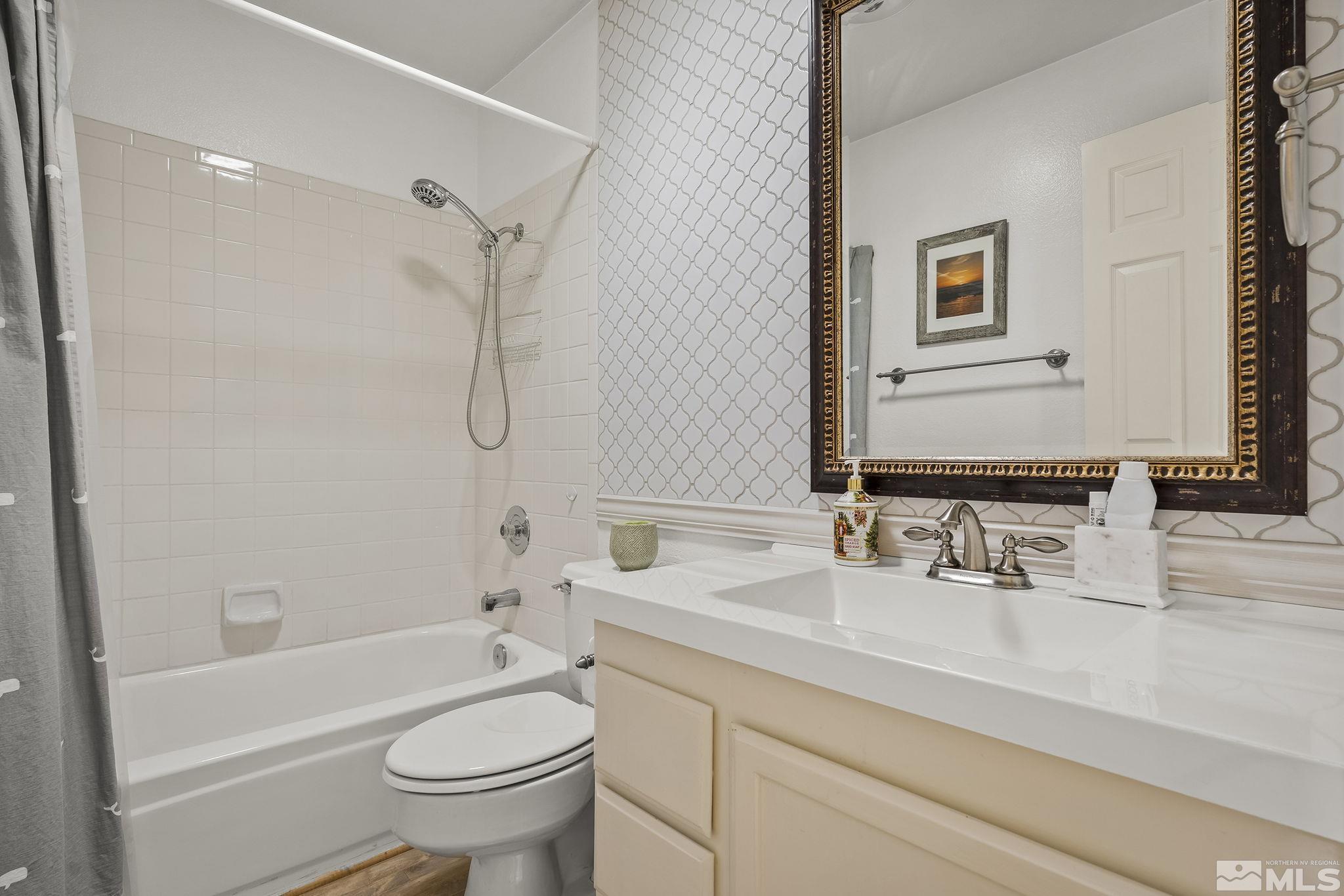 2390 High Terrace Drive Reno, NV 89509 - Photo 17 of 36 a bathroom with a sink a toilet and a mirror