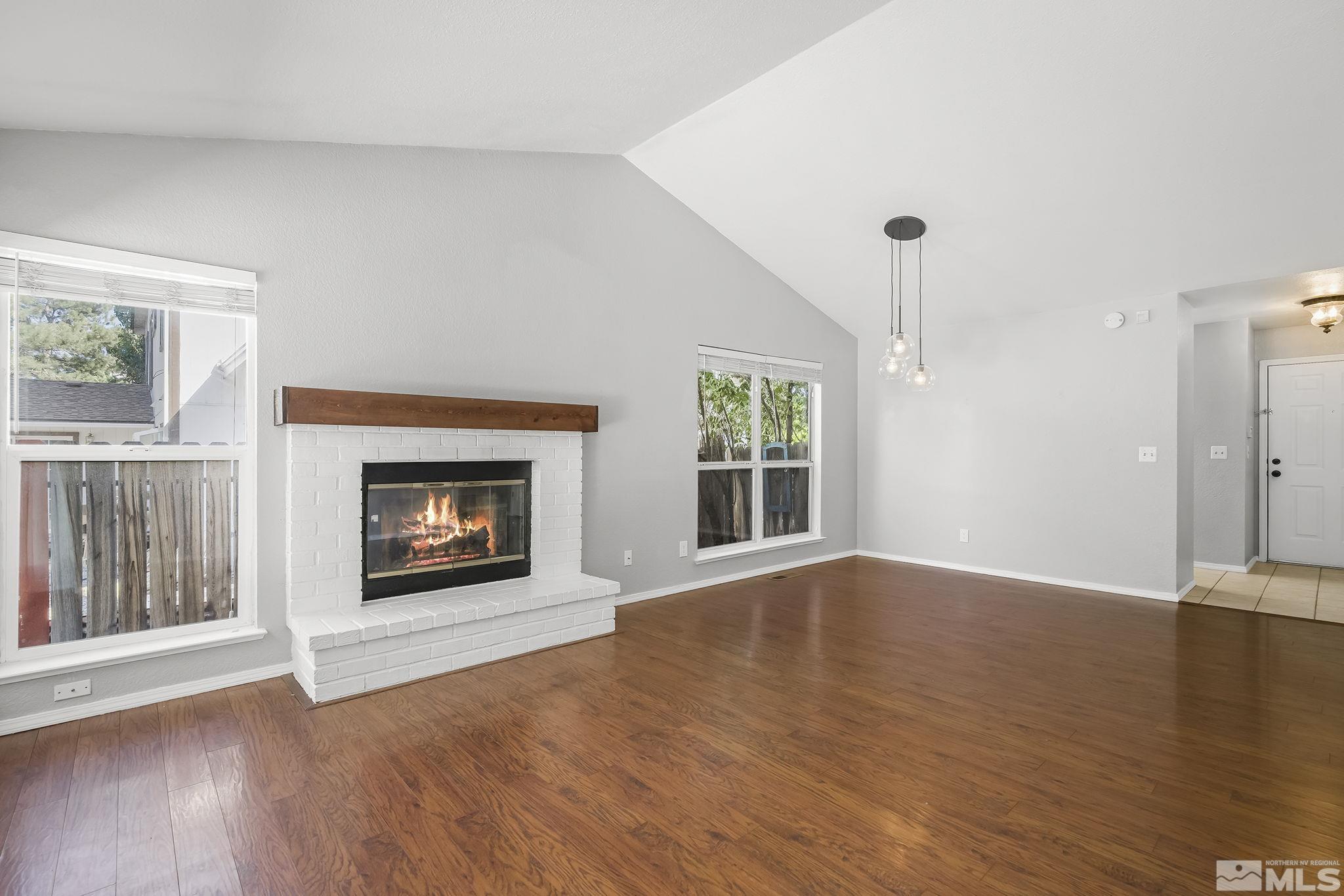 4755 Scenic Hill Circle Reno, NV 89523 - Photo 4 of 20 a view of an empty room with a window and wooden floor