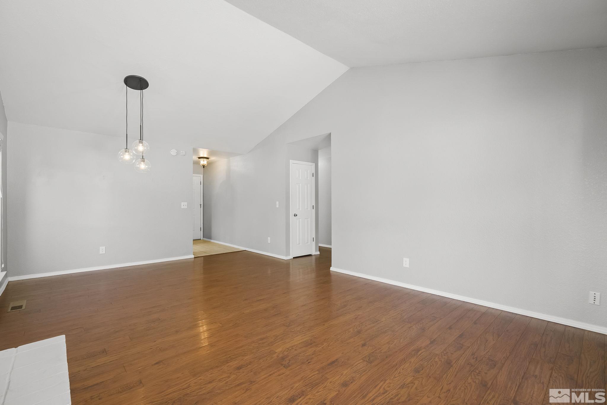 4755 Scenic Hill Circle Reno, NV 89523 - Photo 5 of 20 a view of an empty room with a window and wooden floor