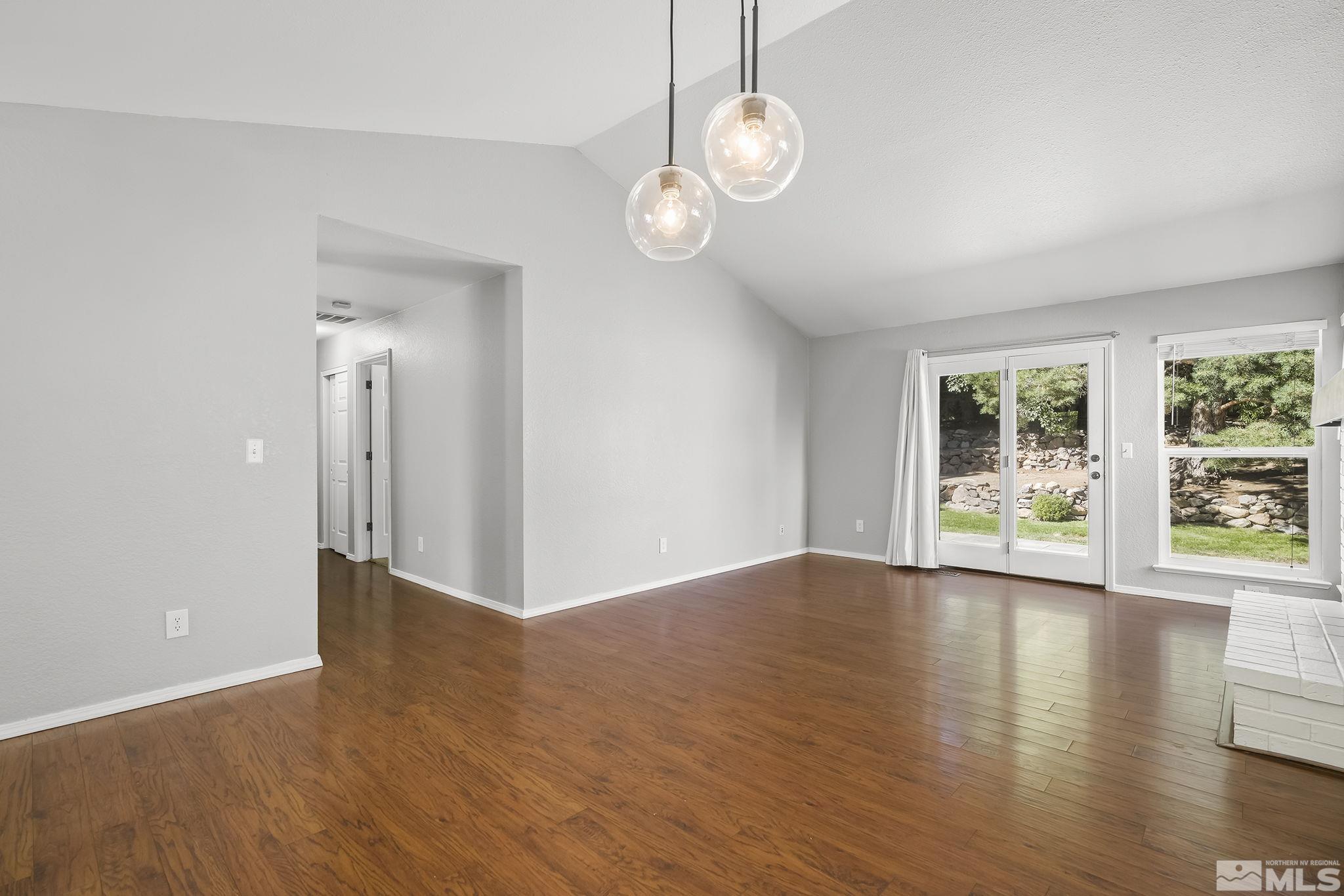 4755 Scenic Hill Circle Reno, NV 89523 - Photo 6 of 20 a view of an empty room with wooden floor and a window