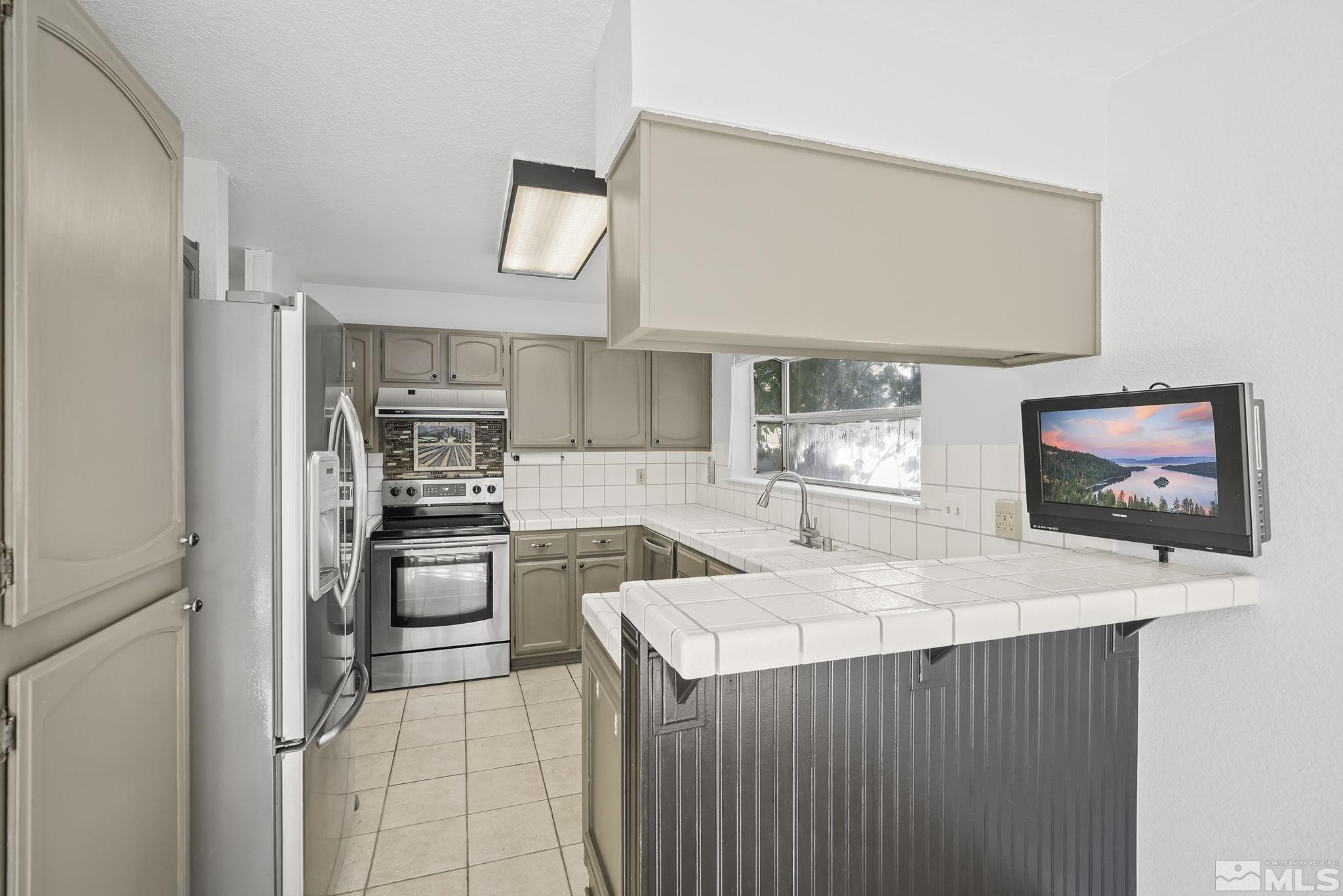 4755 Scenic Hill Circle Reno, NV 89523 - Photo 8 of 20 a kitchen with stainless steel appliances a stove microwave and a refrigerator