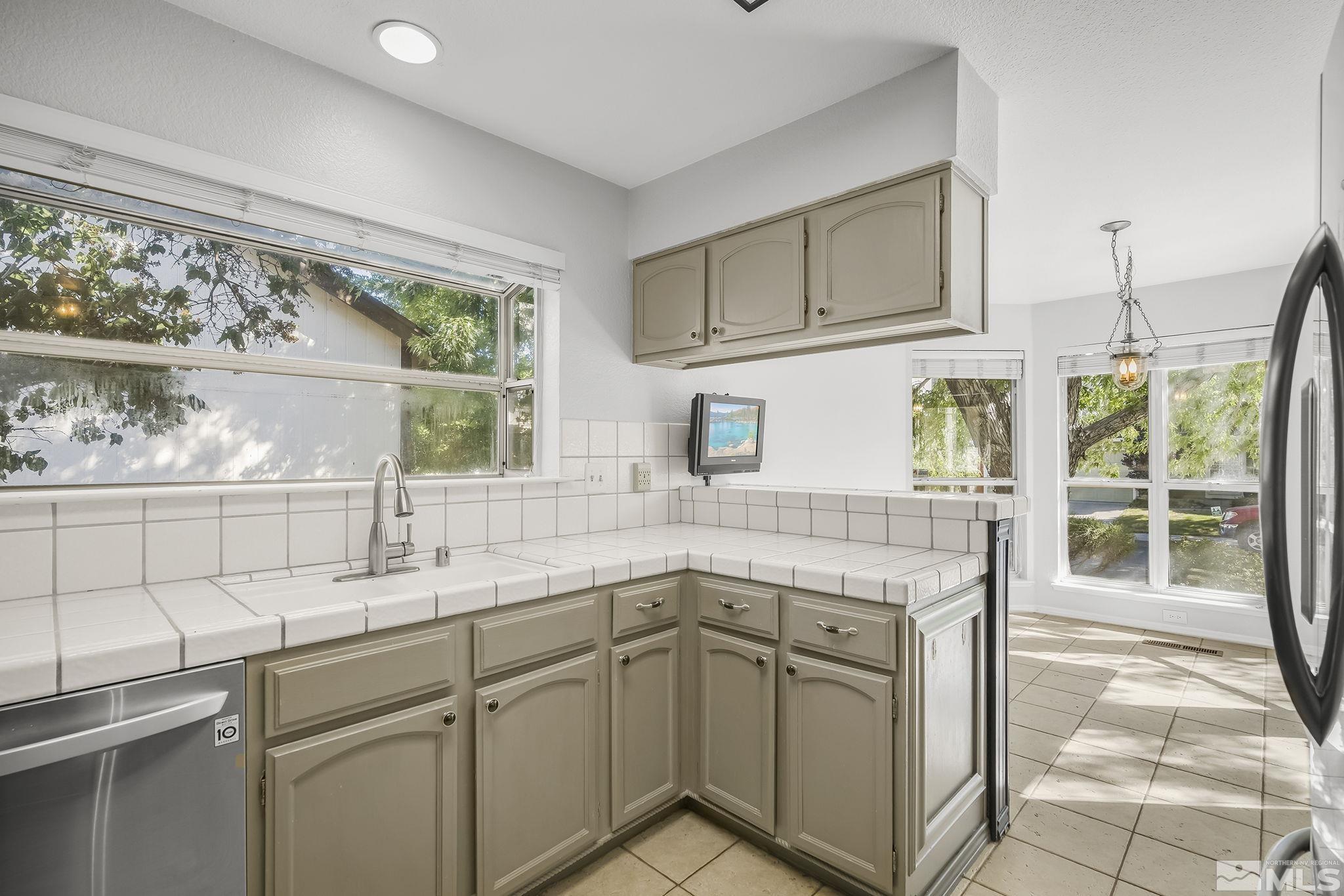 4755 Scenic Hill Circle Reno, NV 89523 - Photo 9 of 20 a kitchen with stainless steel appliances granite countertop a sink and a window