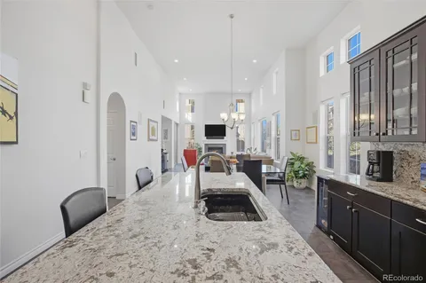 a kitchen with stainless steel appliances granite countertop sink stove refrigerator and cabinets