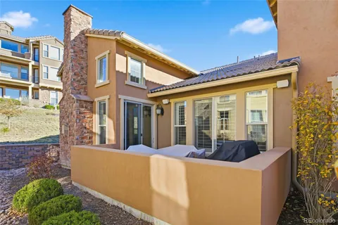 a view of a building with a large window and potted plants