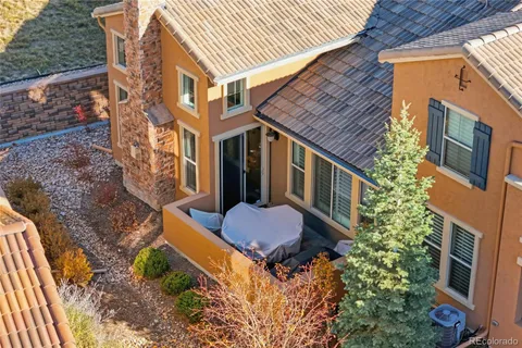 a aerial view of a house with backyard and trees