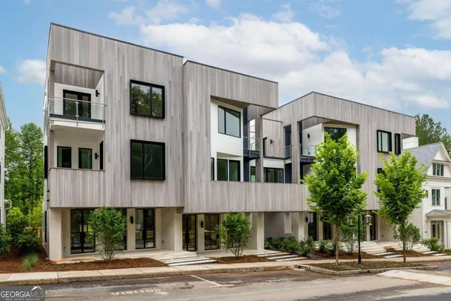 a view of a patio with table and chairs potted plants and floor to ceiling window and potted plants
