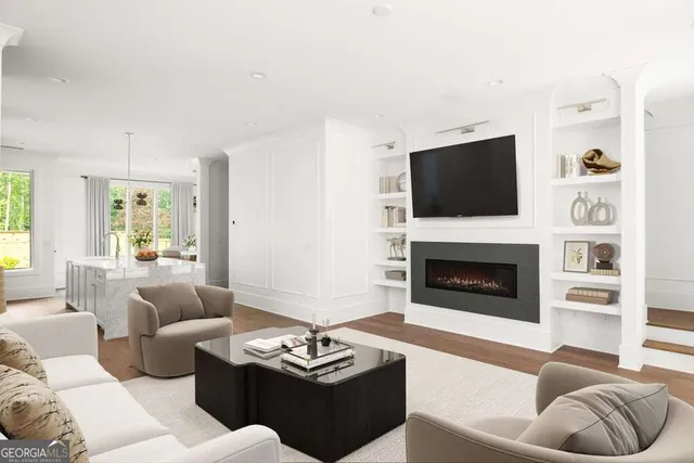 a kitchen with kitchen island granite countertop a stove a sink a dining table and chairs with wooden floor