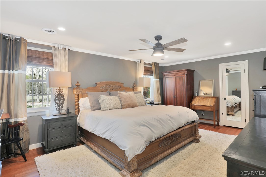 2601 Kentford Road Midlothian, VA 23113 - Photo 20 of 35 a bedroom with a large bed and a chandelier
