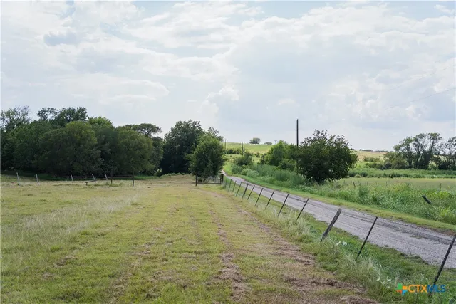 a view of a field with an trees
