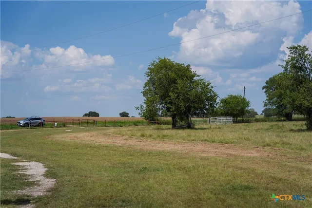 a hallway with a couch and chandelier
