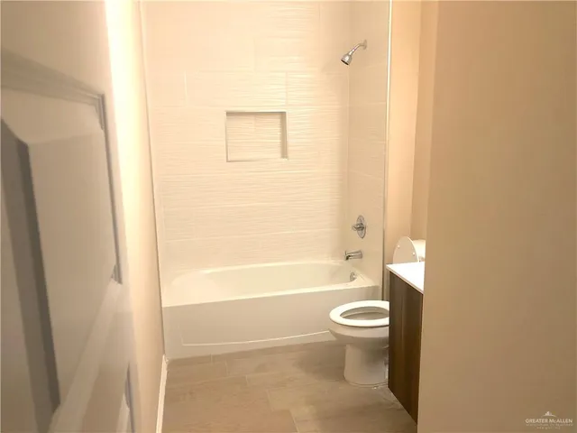 a bathroom with a toilet and a bathtub