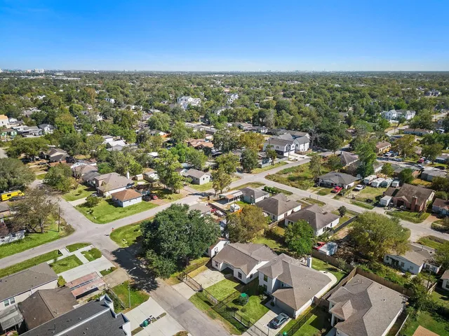 an aerial view of residential houses with city view
