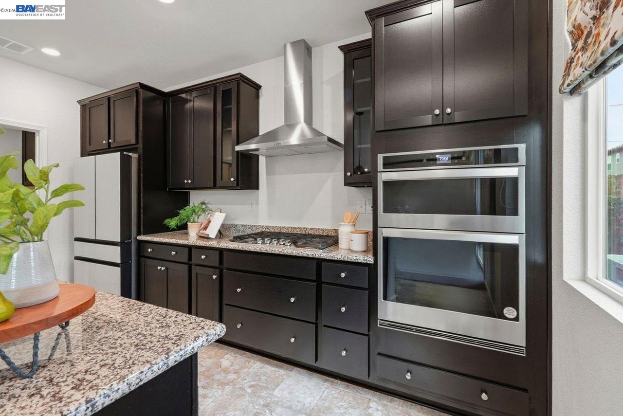 1444 Meridian Street Manteca, CA 95337 - Photo 13 of 45 a kitchen with granite countertop cabinets and steel stainless steel appliances