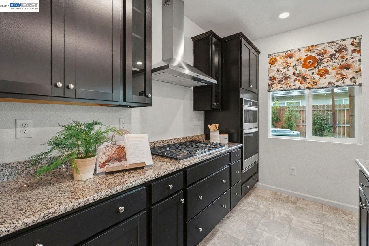 1444 Meridian Street Manteca, CA 95337 - Photo 14 of 45 a kitchen with stainless steel appliances granite countertop a sink a stove and a refrigerator