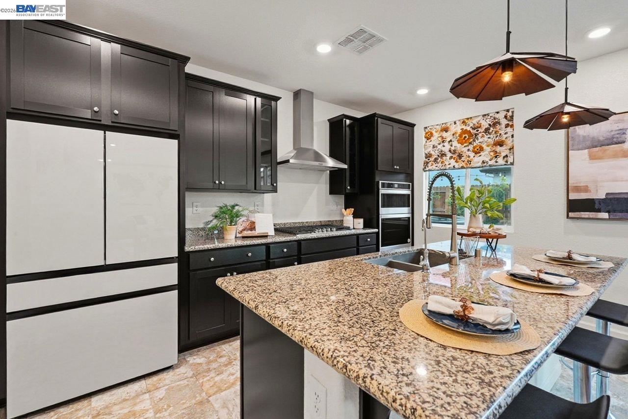 1444 Meridian Street Manteca, CA 95337 - Photo 15 of 45 a kitchen with stainless steel appliances granite countertop a sink a refrigerator and a stove