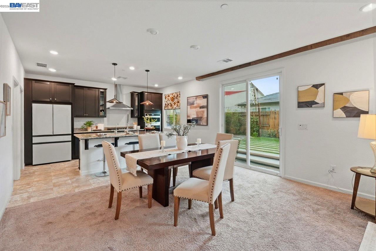 1444 Meridian Street Manteca, CA 95337 - Photo 18 of 45 a kitchen with kitchen island a dining table and chairs