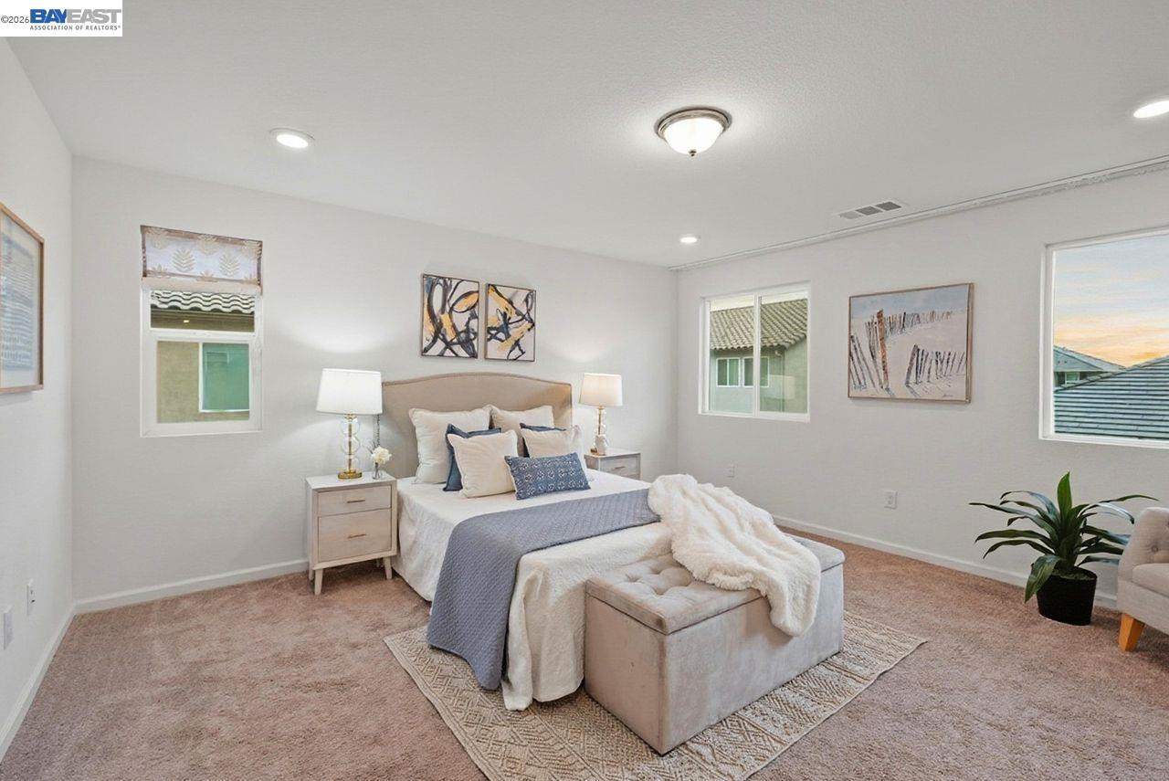 1444 Meridian Street Manteca, CA 95337 - Photo 21 of 45 a bedroom with a large bed and a potted plant