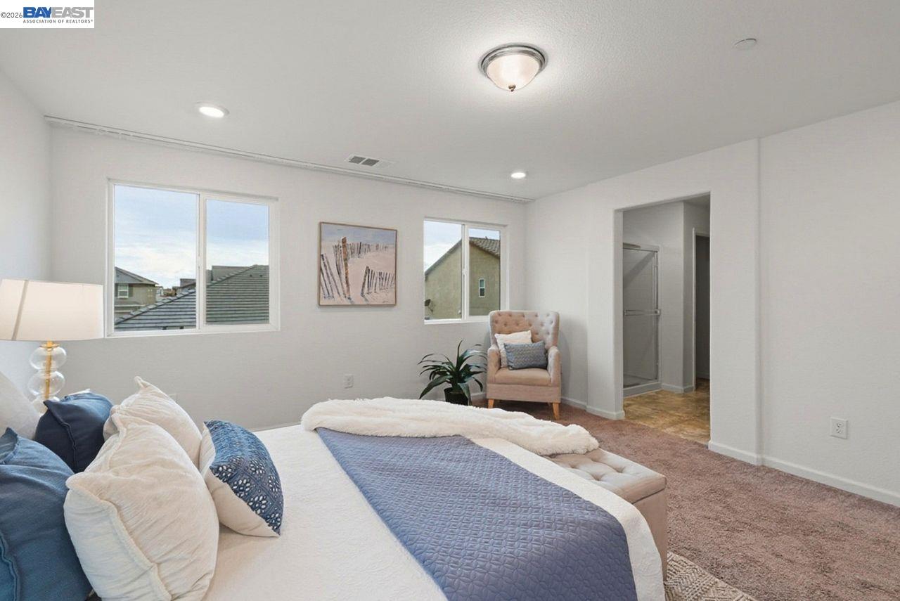 1444 Meridian Street Manteca, CA 95337 - Photo 22 of 45 a bedroom with a large bed and a window