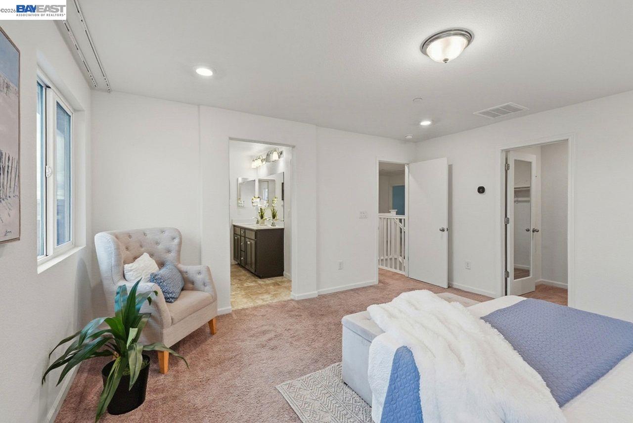 1444 Meridian Street Manteca, CA 95337 - Photo 24 of 45 a spacious bedroom with a bed and a couch