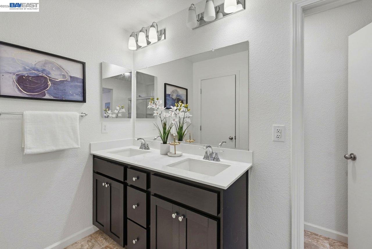 1444 Meridian Street Manteca, CA 95337 - Photo 25 of 45 a bathroom with a sink and a mirror