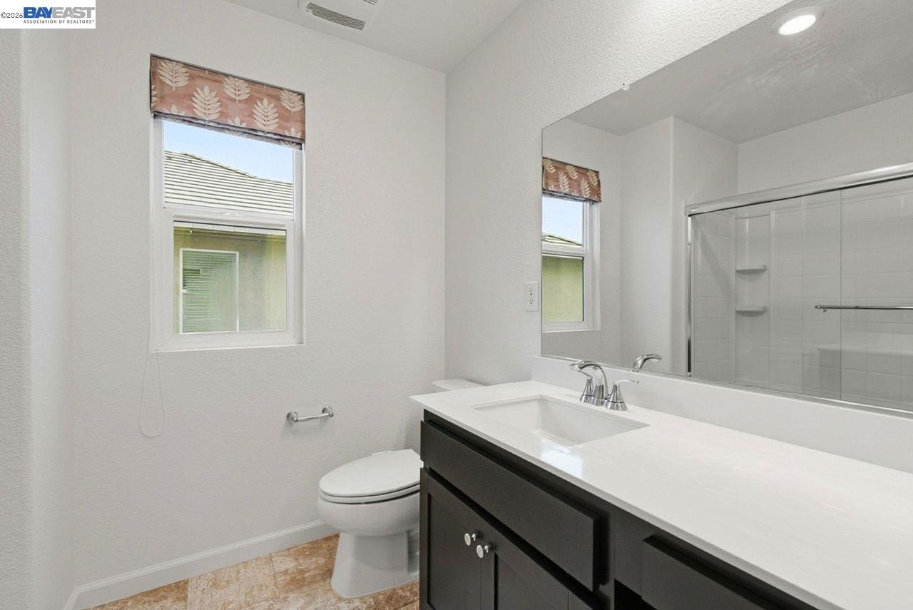 1444 Meridian Street Manteca, CA 95337 - Photo 29 of 45 a bathroom with a sink a toilet and shower