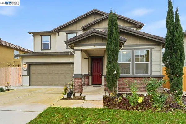 a living room with furniture a rug and wooden floor