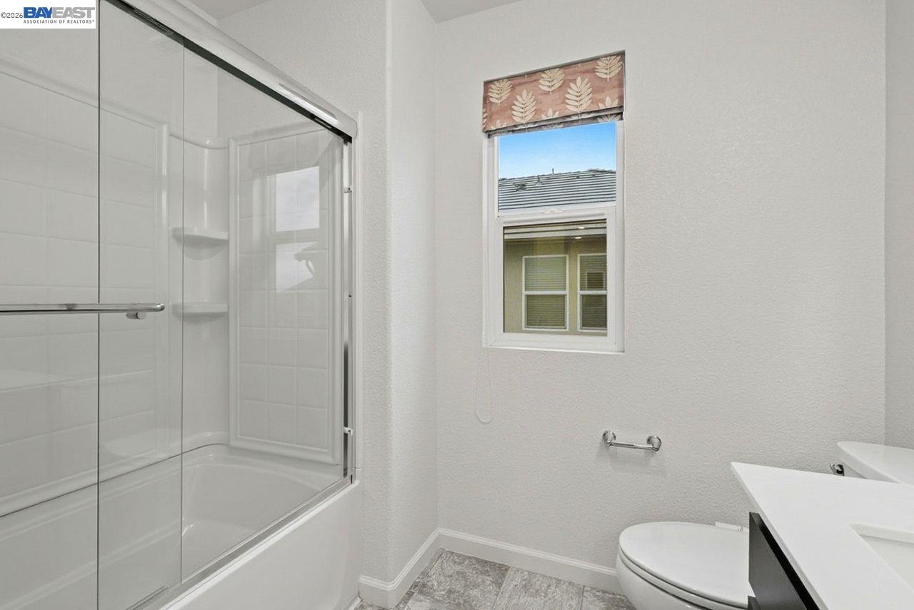1444 Meridian Street Manteca, CA 95337 - Photo 31 of 45 a bathroom with a toilet and shower