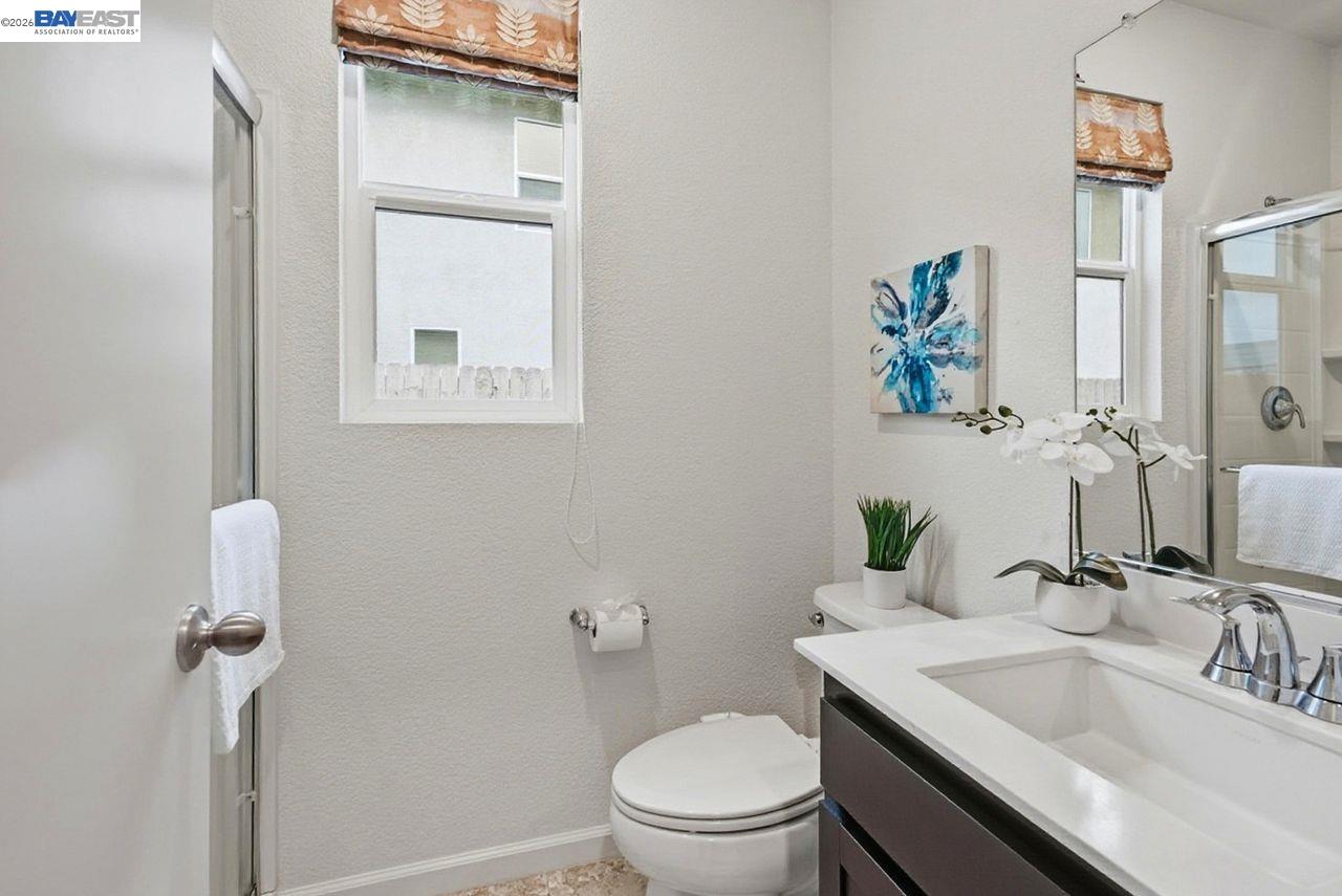 1444 Meridian Street Manteca, CA 95337 - Photo 32 of 45 a bathroom with a sink toilet and vanity