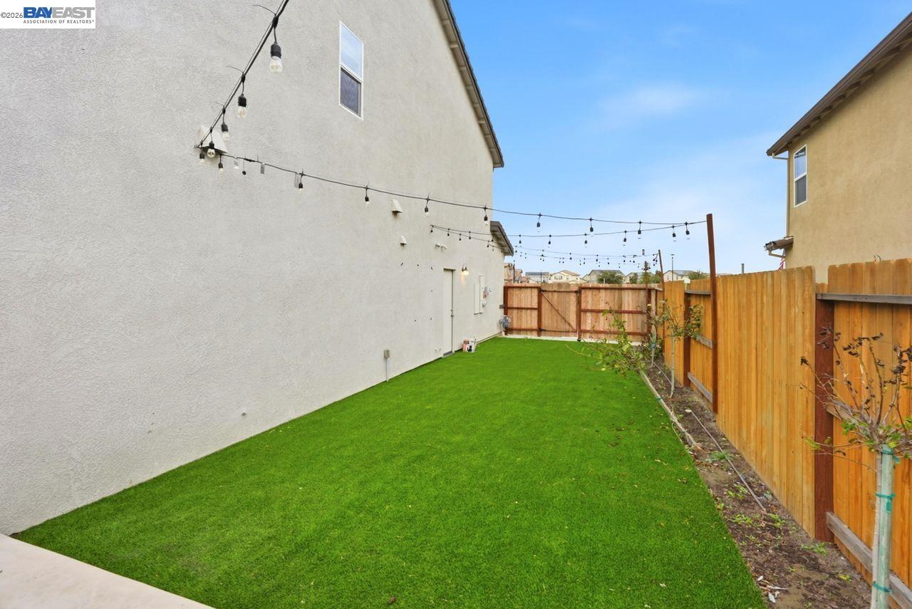 1444 Meridian Street Manteca, CA 95337 - Photo 42 of 45 a view of a backyard with wooden fence