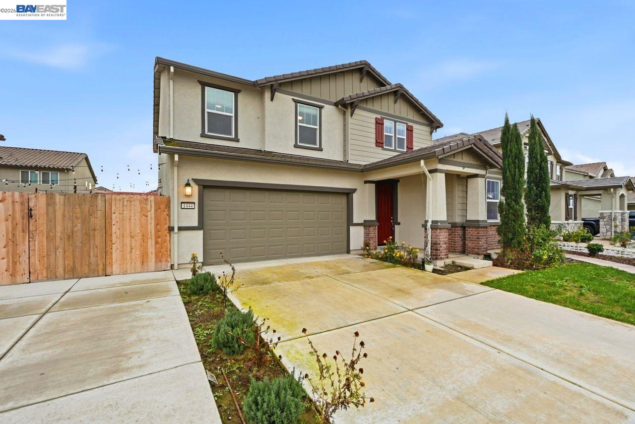 1444 Meridian Street Manteca, CA 95337 - Photo 6 of 45 a front view of a house with a garden and garage