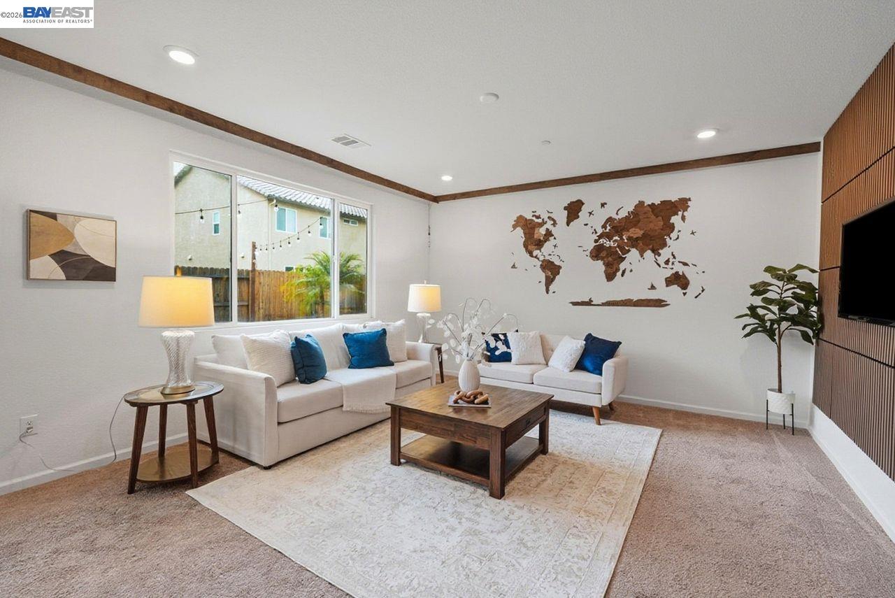 1444 Meridian Street Manteca, CA 95337 - Photo 10 of 45 a living room with furniture and a painting on the wall