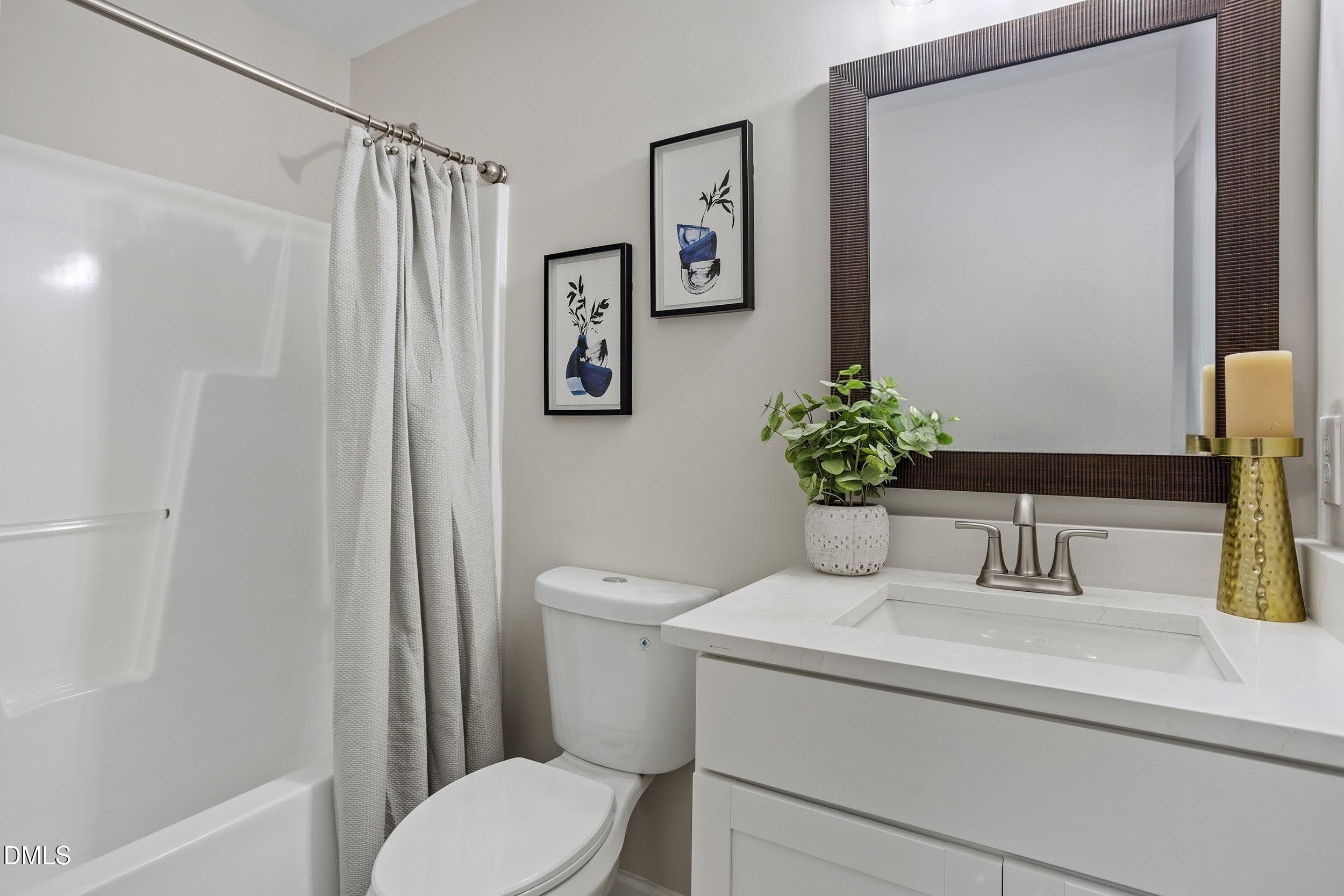 247 Tillamook Drive Wake Forest, NC 27587 - Photo 19 of 30 a bathroom with a toilet sink and vanity