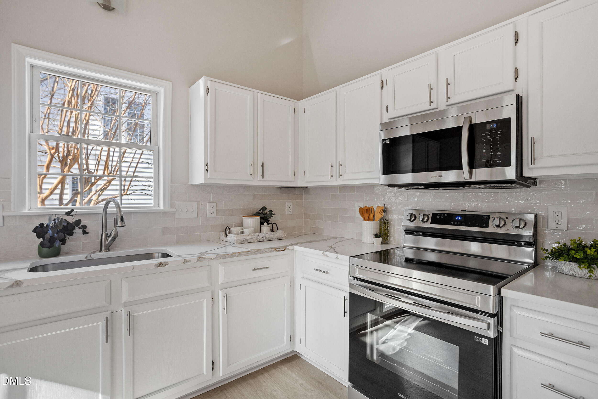 247 Tillamook Drive Wake Forest, NC 27587 - Photo 9 of 30 a kitchen with cabinets appliances a sink and a window