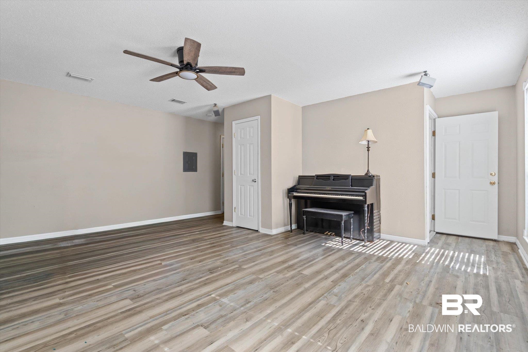180 Creax Road Axis, AL 36505 - Photo 20 of 35 Living room with light wood-type flooring, ceiling fan, and electric panel