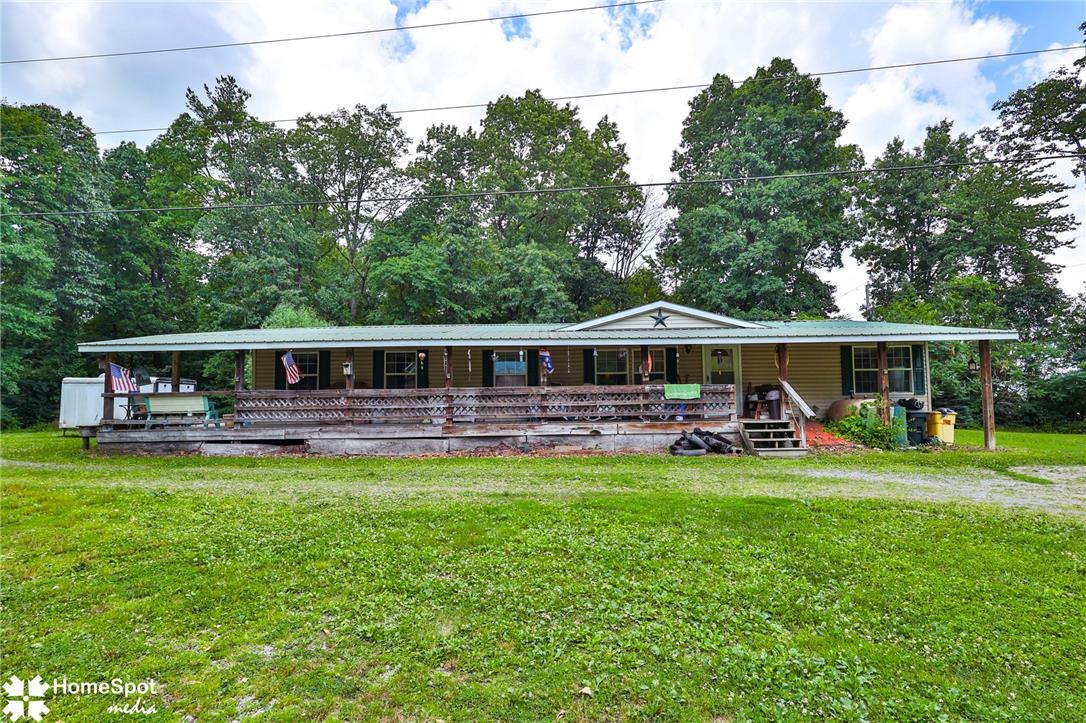 3795 Rhoades Road Kempton, PA 19529 - Photo 2 of 42 A welcoming front porch extends across this charming residence, framed by mature trees and a verdant lawn.