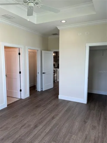 a view of empty room with wooden floor