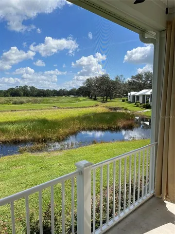 a view of a balcony with a yard