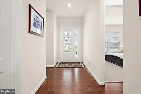 a living room with furniture a rug and kitchen view