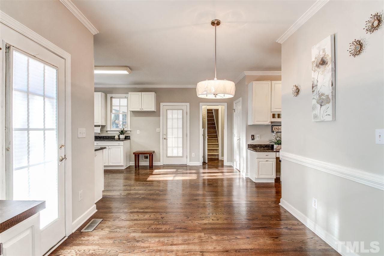 9024 Hemingwood Court Raleigh, NC 27613 - Photo 12 of 28 a view of large living room with white walls and kitchen view