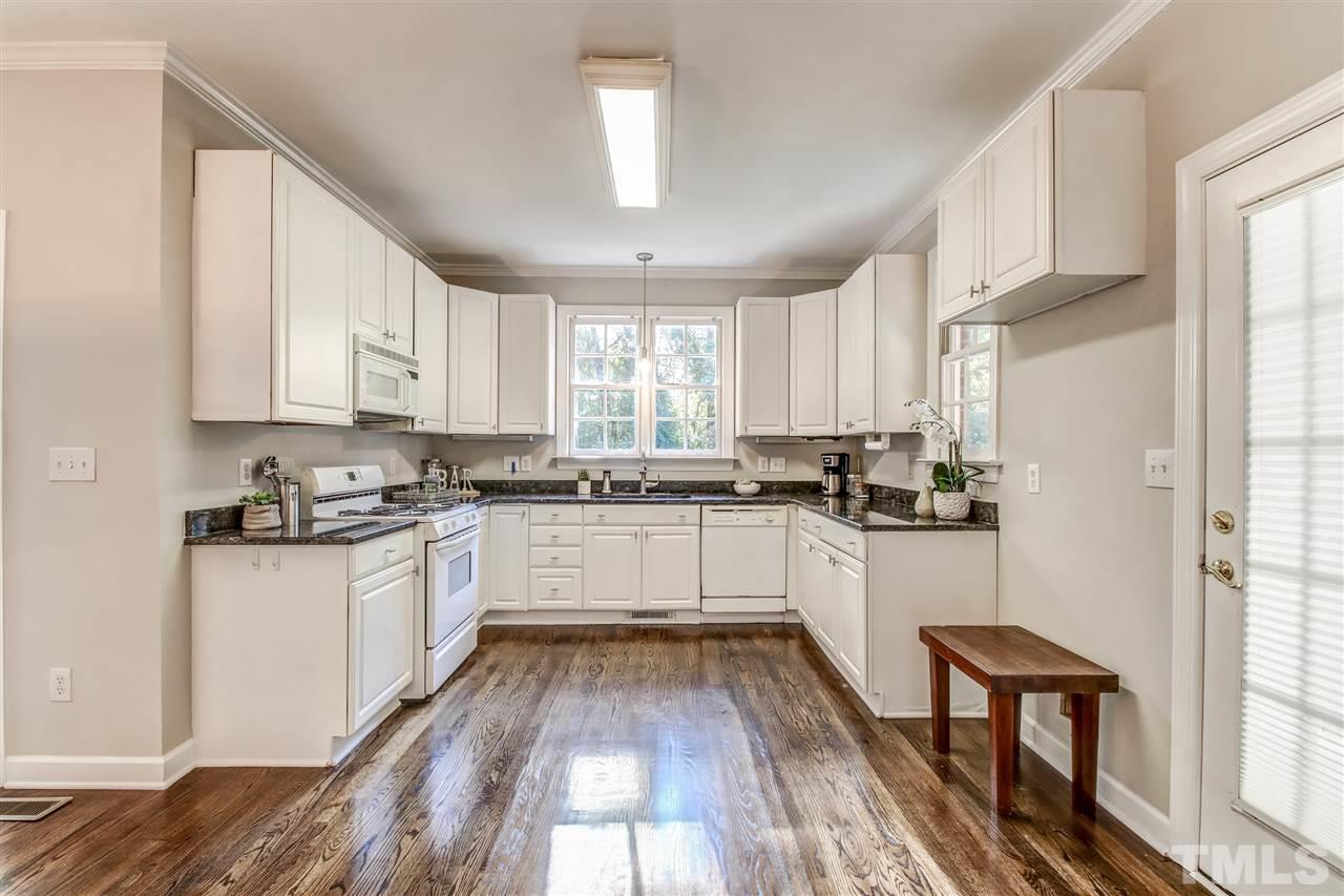9024 Hemingwood Court Raleigh, NC 27613 - Photo 15 of 28 a kitchen with granite countertop white cabinets and white appliances