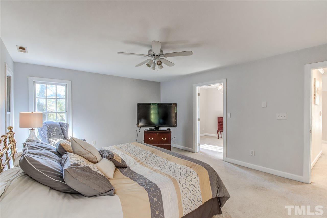 9024 Hemingwood Court Raleigh, NC 27613 - Photo 19 of 28 a bedroom with a bed and a flat screen tv