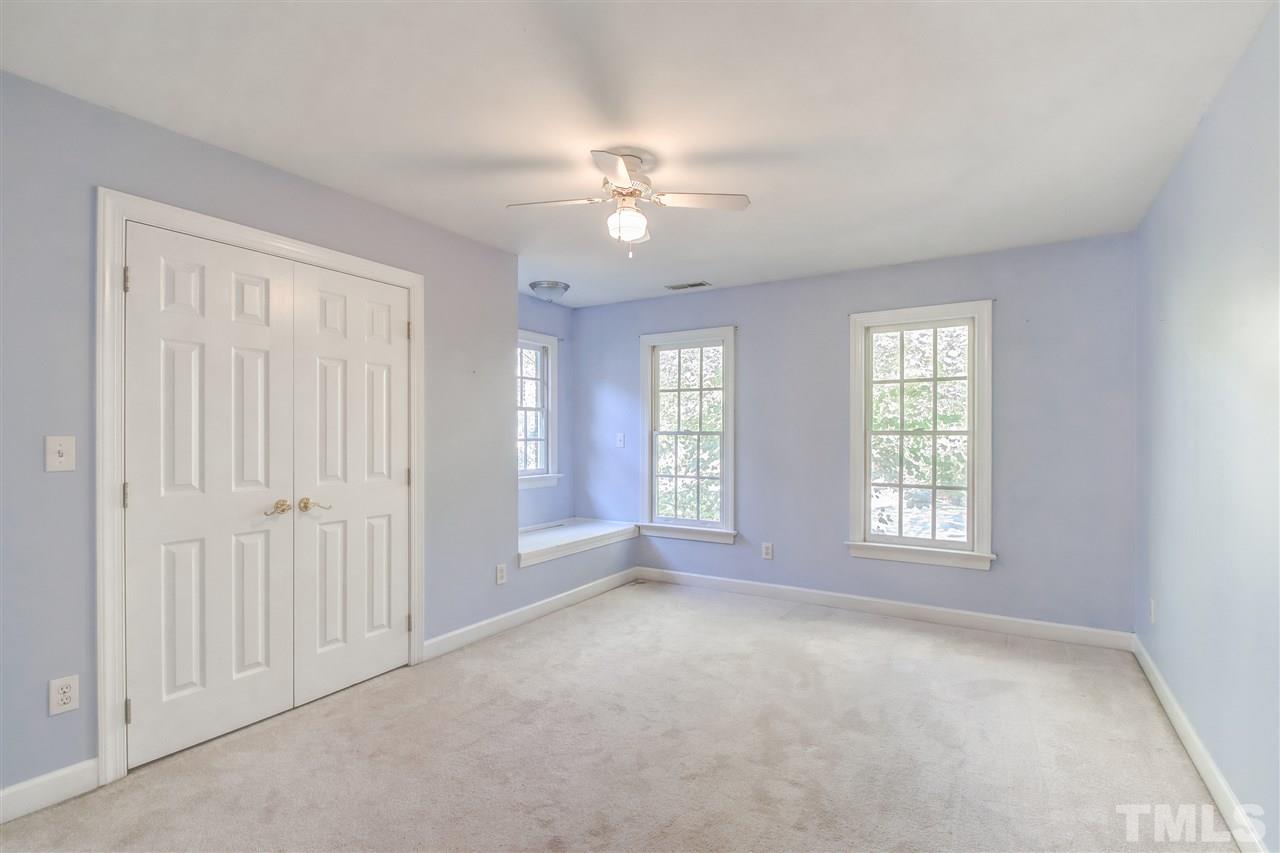 9024 Hemingwood Court Raleigh, NC 27613 - Photo 22 of 28 a view of an empty room with chandelier fan and windows